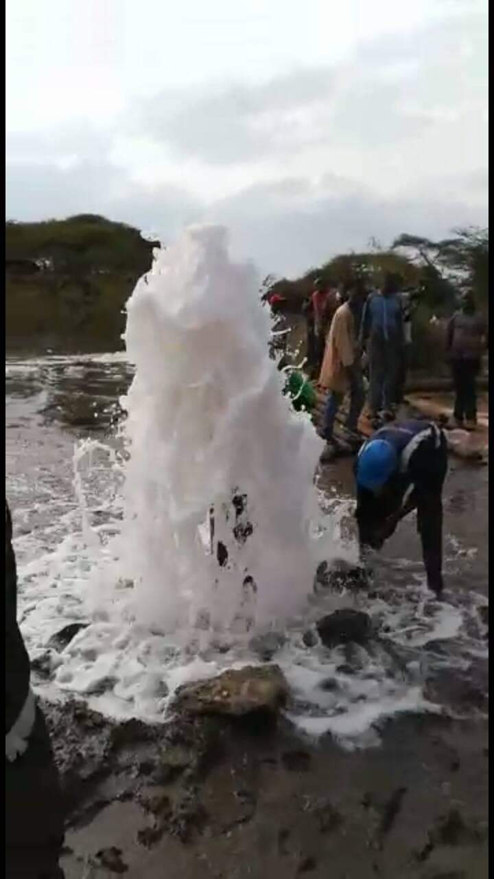 A drilling rig in action at a site.